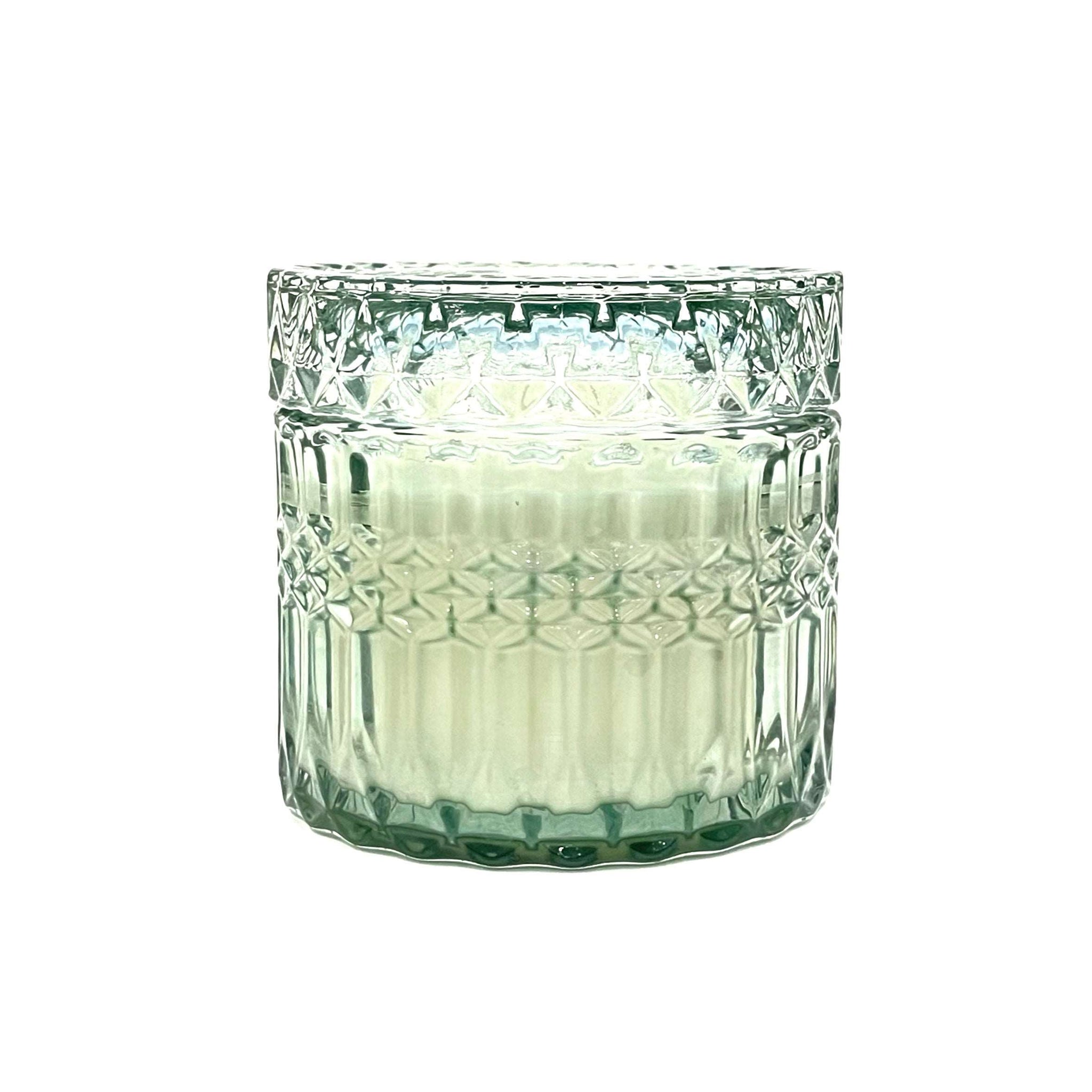 Imagine a fresh summertime herb garden.  This scent embodies the aroma of cool, crisp notes of fresh picked mint leaves mixed with ripe cucumbers plucked straight off the vine.  Vintage-inspired vessel in a fresh shade of lucent green glass with a lid and cotton wick. Hand poured with 7oz of soy wax.  60 hour burn time. 