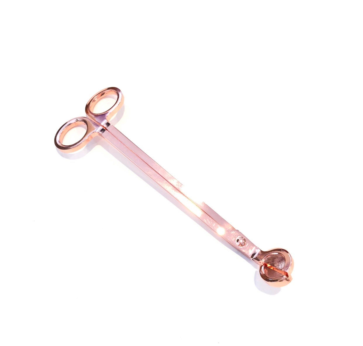 Trimming your wick in between burns will allow for a cleaner burn, even flame, and a longer lasting candle.  Our metal wick trimmers clip wicks to the perfect length even in a deep container.  Rose gold.