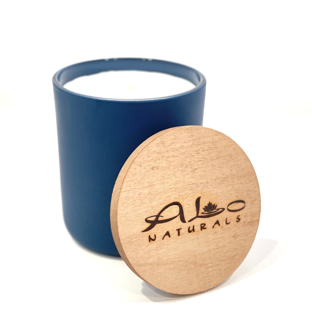 Deep Blue Ocean soy wax candle. Smells fresh, clean, and masculine. Hand poured in a navy blue frosted glass vessel with a cotton wick and maple wood lid. Enjoy 75+ hours of burn time!