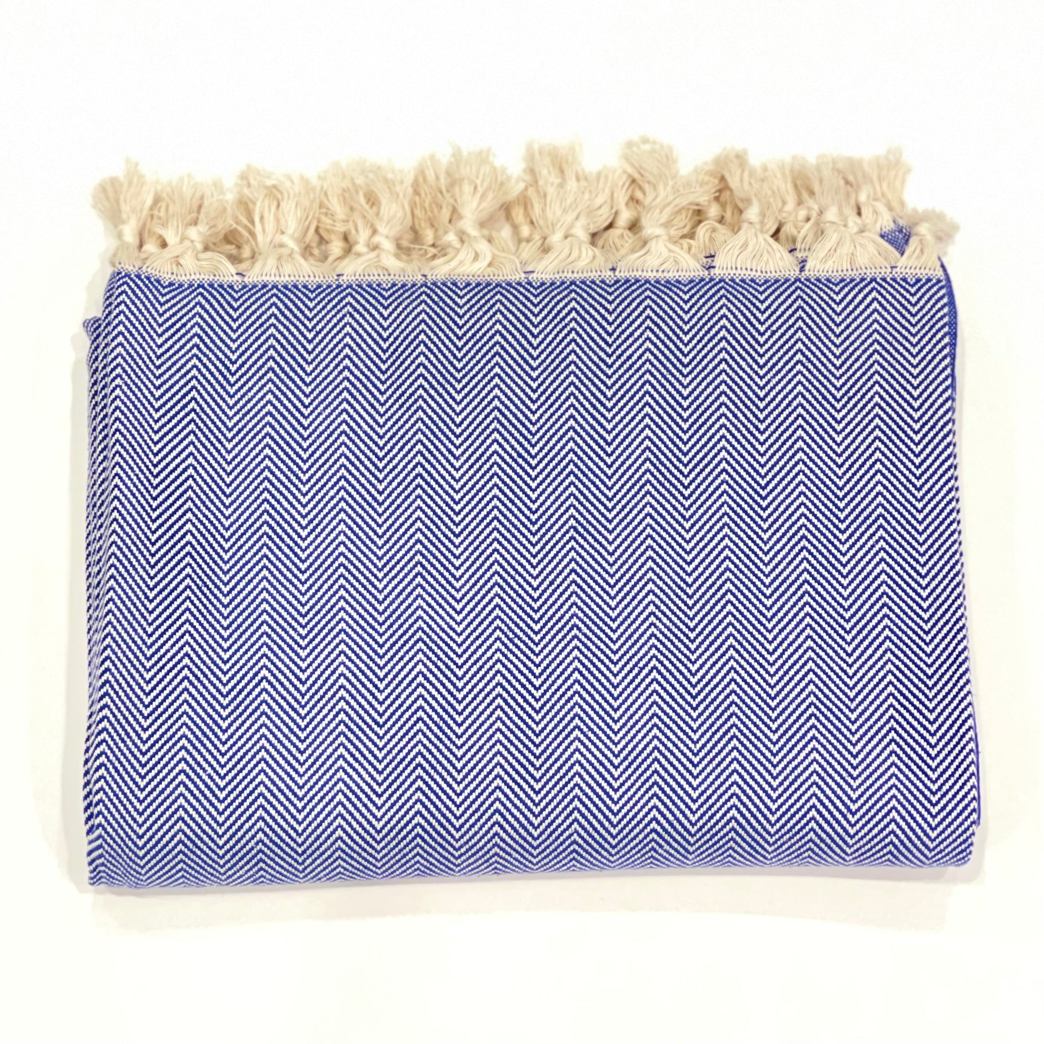 This beautiful throw blanket is hand loomed in a true blue herringbone pattern with 100% Turkish Cotton. Known for its softness, comfort, light weight, hypoallergenic, and antimicrobial properties. Can be used as a throw blanket on a bed, couch, picnic, or even at the beach! Get ready to stay warm and comfy! Fair trade. Measure 71"x 94.5". XL King size. Perfect snuggle on the couch!