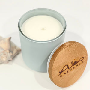 Saint Simons Sea Breeze candle.  Hand poured in a frosted light blue vessel with a cotton wick and maple wood lid.  13 ounces.  70+ hours of burn time!